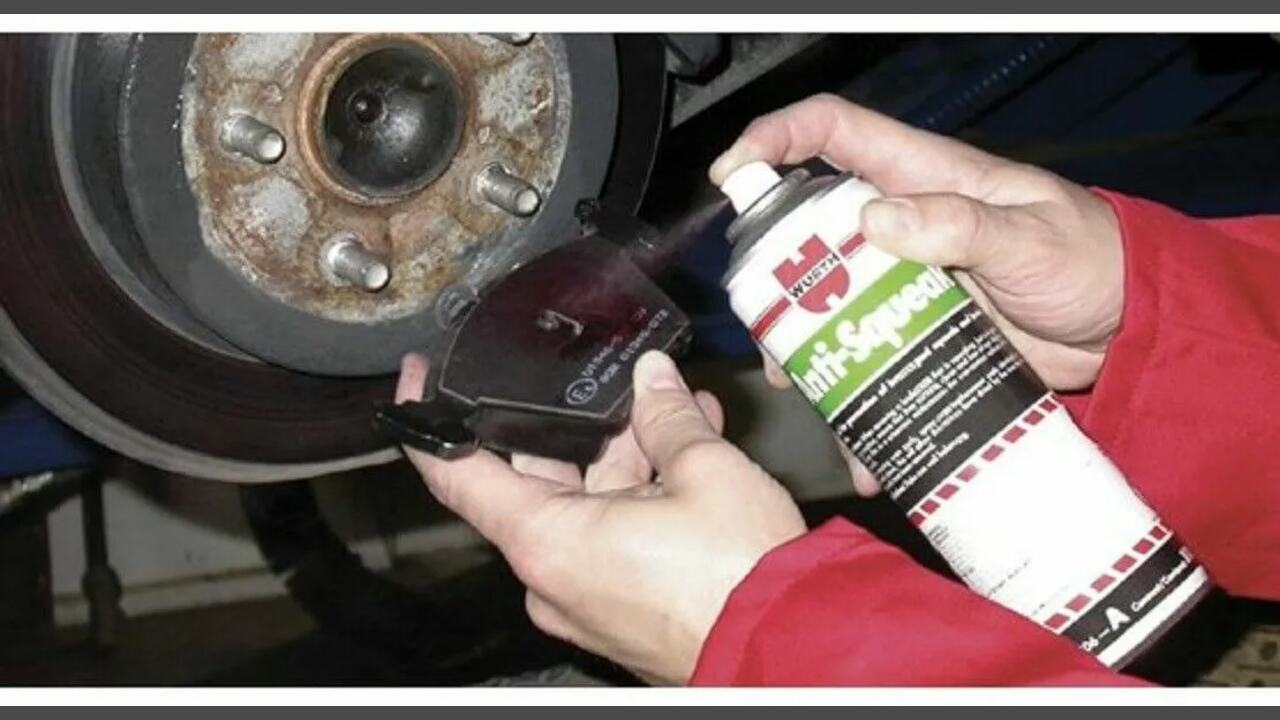Applying The Spray To The Back Of The Brake Pads